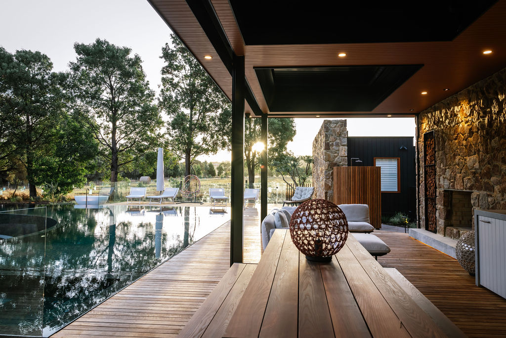 Sunset at the resort pool with illuminated outdoor lighting in pool house